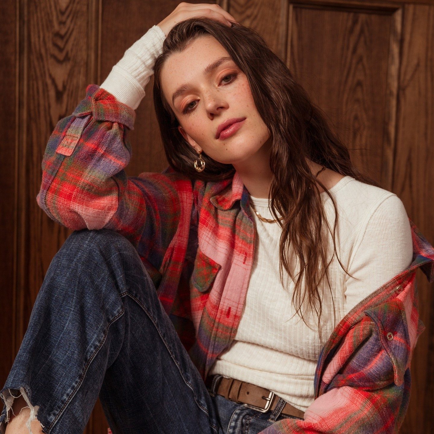 EDP TN AMERICAN EAGLE model wearing plaid and a white long sleeve sitting down