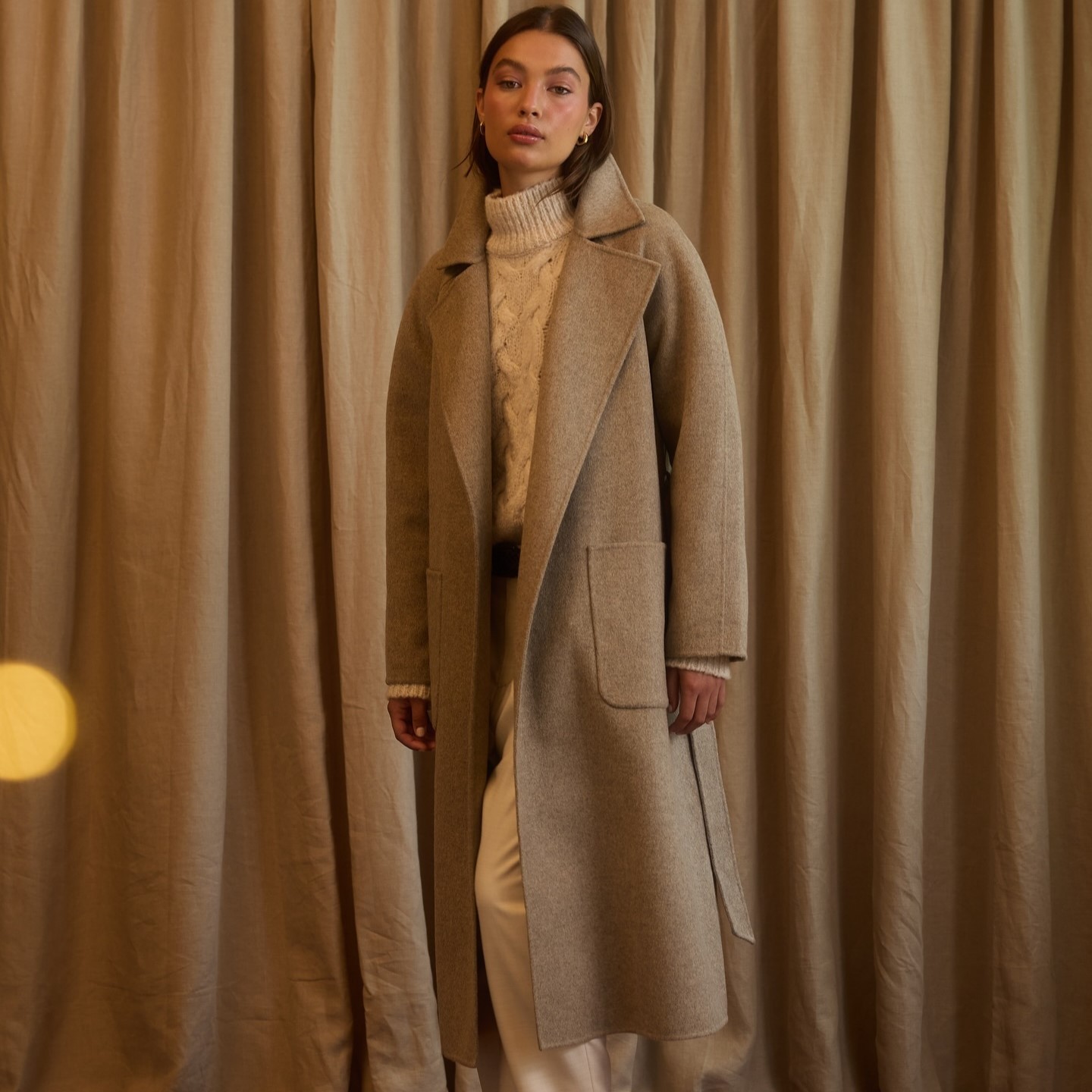 EDP DEC TN AEO-dec A model wearing a tan winter outfit from American Eagle